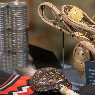 The Poarch Creek Indians Museum exhibits stickball items, patchwork, a turtle rattle, and tin can rattles.